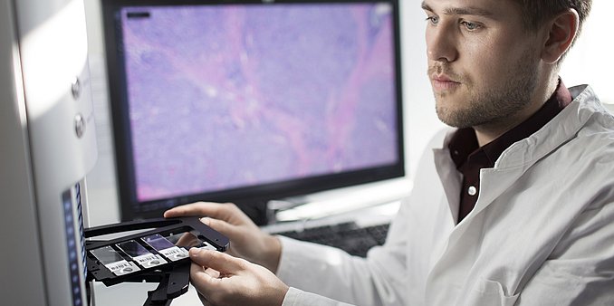 Tumor profiling scientist placing samples into profiler