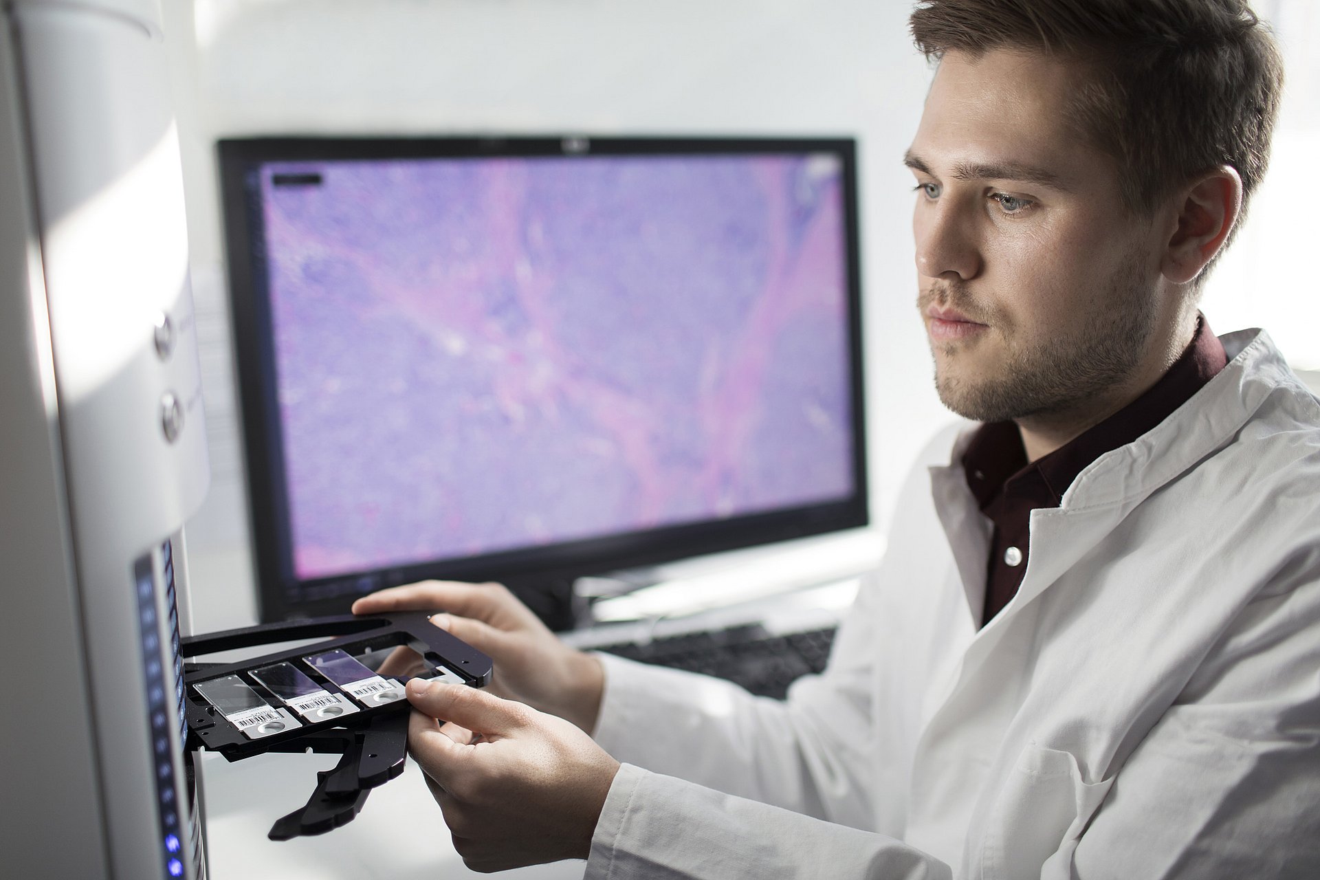 Tumor profiling scientist placing samples into profiler